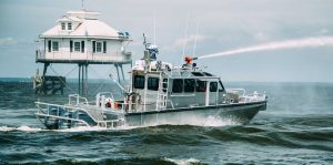 Silver Ships Endeavor Series fire boat spraying water on the ocean