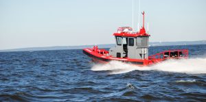 Red and gray Tow Boat U.S. Ambar boat on open ocean